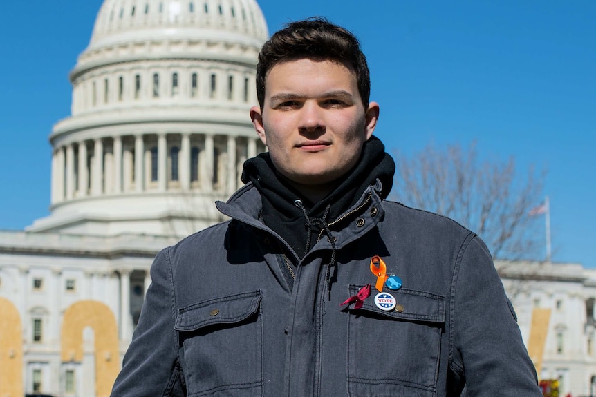 John Barnitt poses for the camera with the US Capitol building behind him.