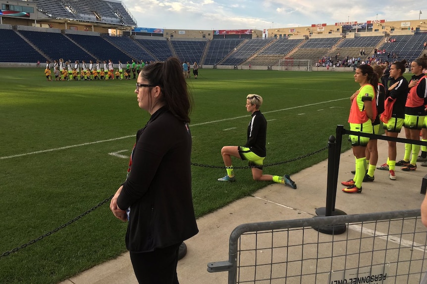 Megan Rapinoe kneels during US national anthem