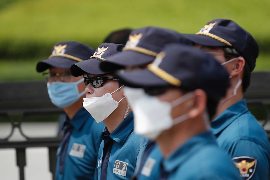 South Korean police officers wearing face masks to help protect against the spread of the new coronavirus.