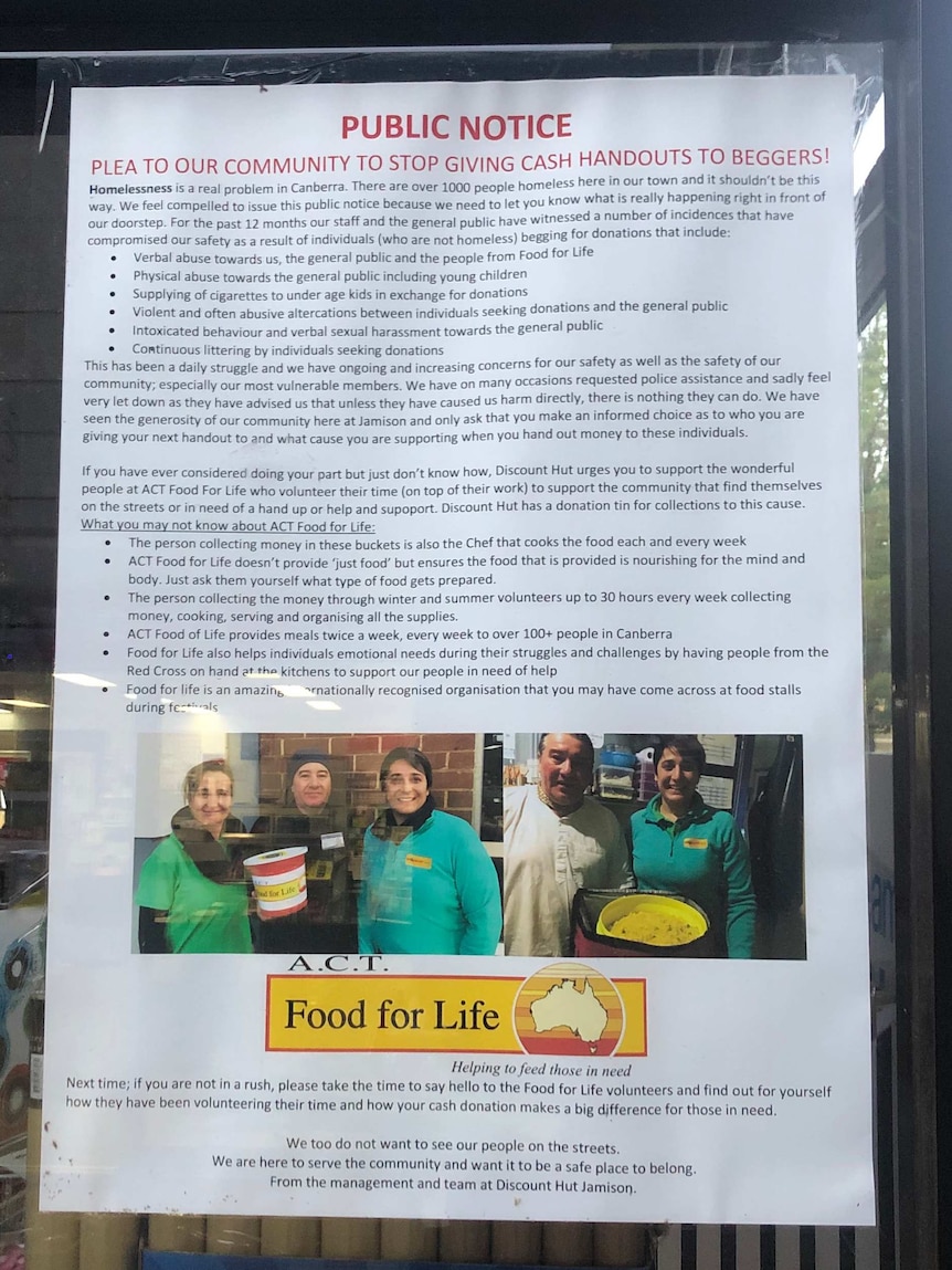 A poster stuck inside a window asking community members to stop giving cash handouts to beggars.