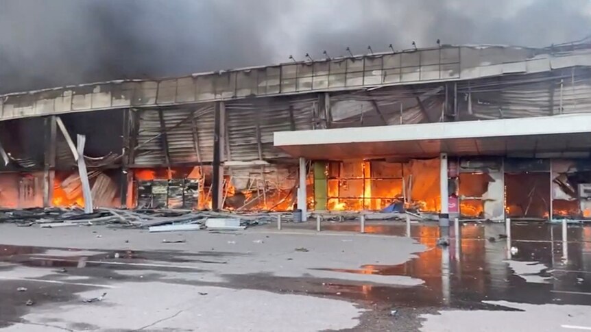 Smoke and fire raises from a shopping mall hit by a Russian missile strike.