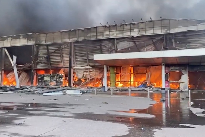 Smoke and fire raises from a shopping mall hit by a Russian missile strike.