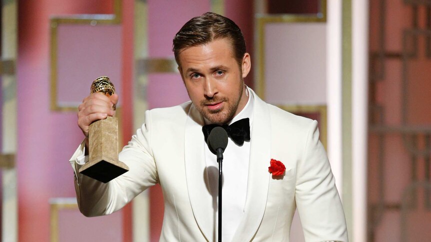Ryan Gosling with the Golden Globe award for best actor in a motion picture musical or comedy.