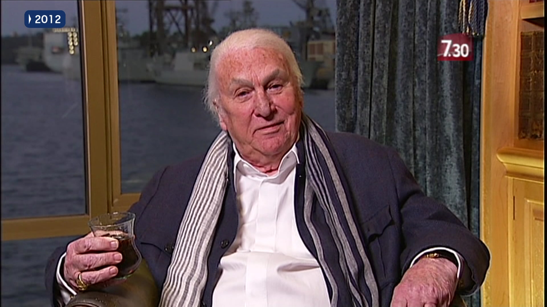 John Laws sitting down with a glass of whiskey