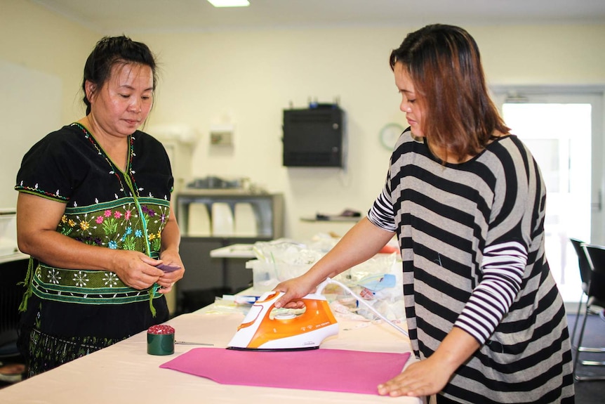 Karen refugees from Nhill, Reehta Say and Cho Lay Nwe ironing her apron, she made in the sewing class.