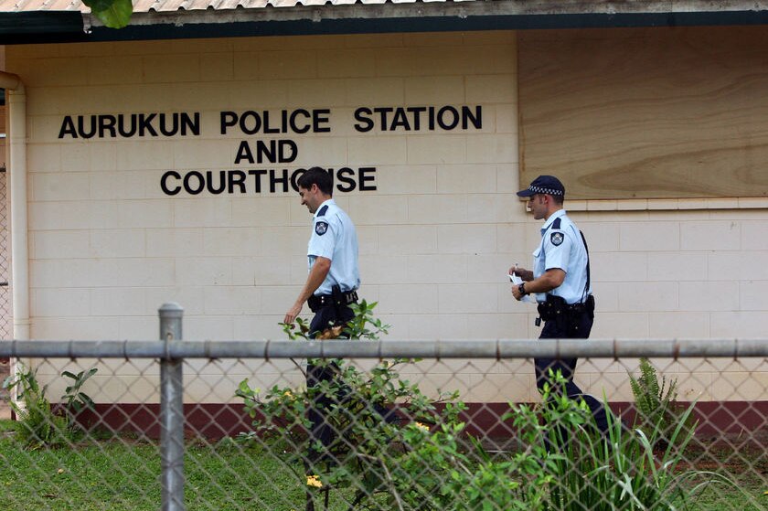Police officers walk into Aurukun Police Station in Far North Queensland.