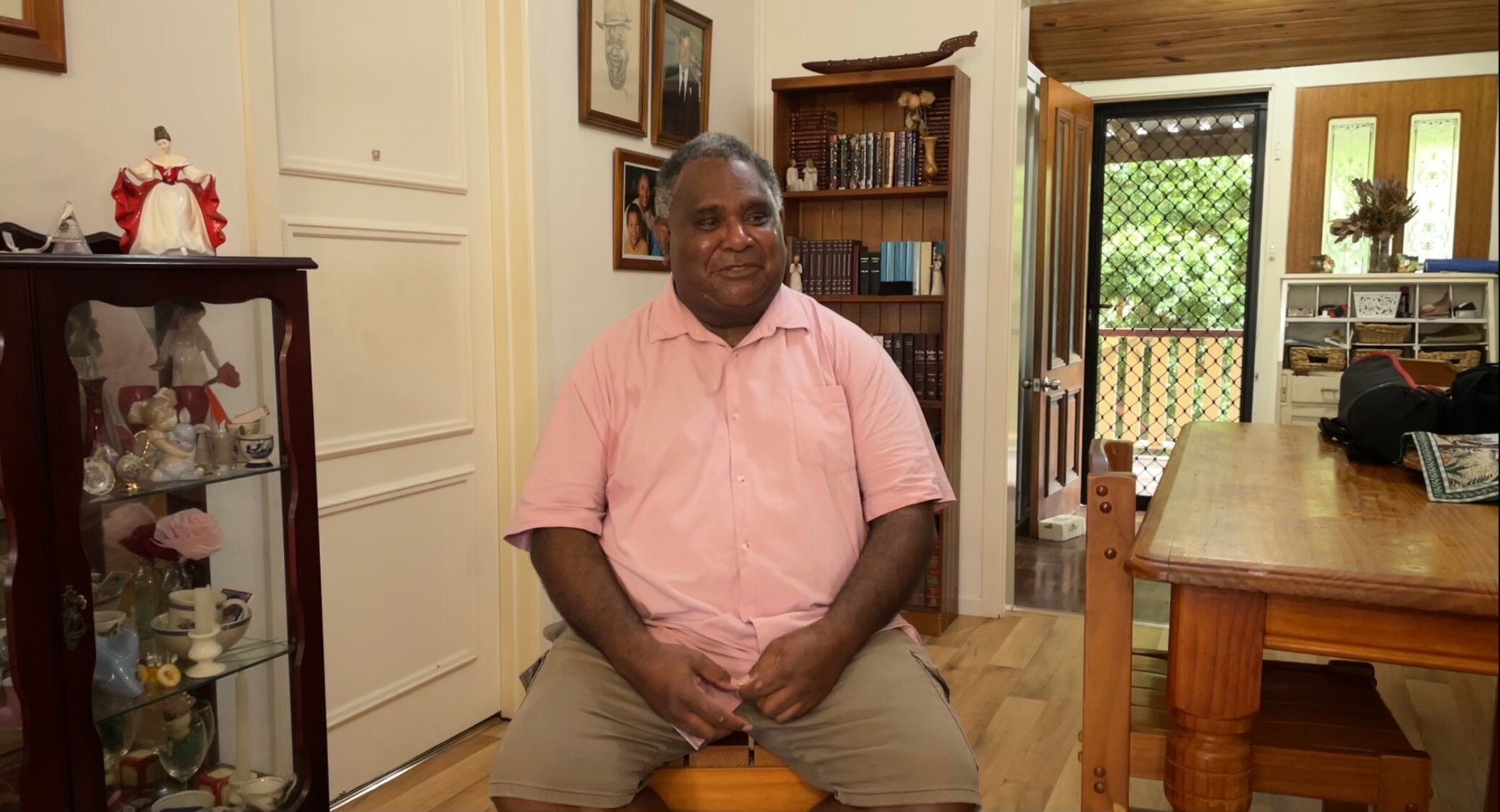 A man sits for an interview with a journalist.