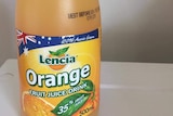 a full bottle of orange juice against a plain white background