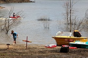 Visitors play in the water at lake Eppalock