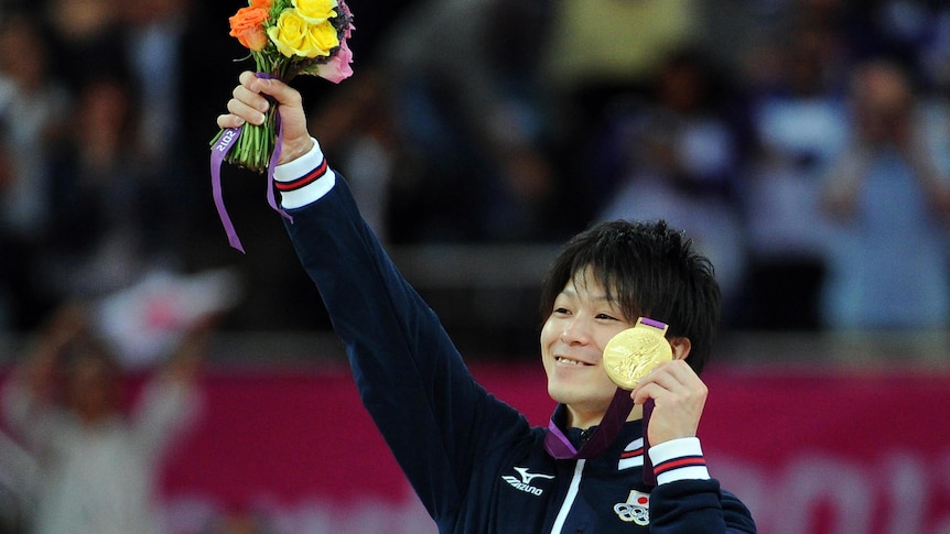 Kohei Uchimura with his gold medal after the artistic gymnastics men's individual all-around final.