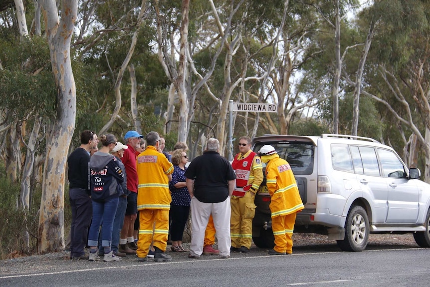 Residents wait to be let through road blocks at Carwoola fire.