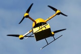 A yellow delivery drone with four black rotors called a "parcelcopter"