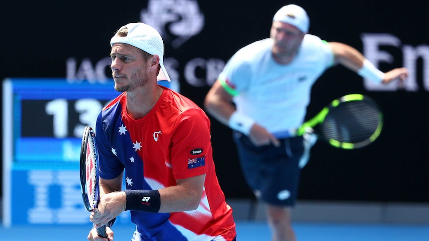Australia's Lleyton Hewitt in foreground with Sam Groth (R) in men's doubles at the Australian Open.