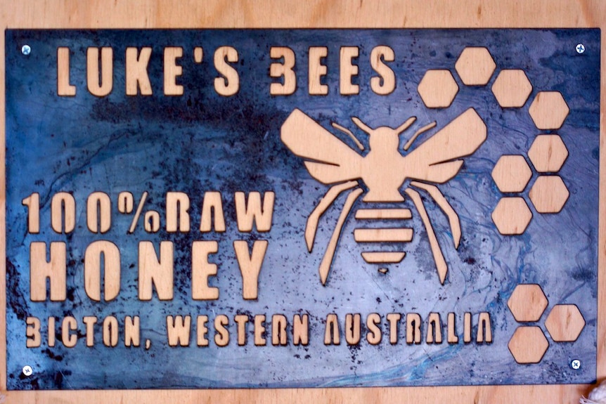 A sign advertising honey produced by Luke's Bees, a business run by beekeeper Luke de Laeter, 16.