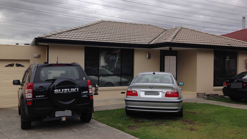 Melbourne house raided with two cars out front