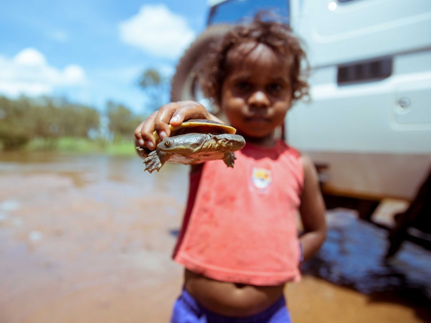 Tahan holds a turtle