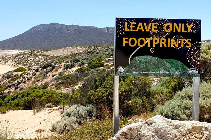 A sign on a beach clifftop saying Leave Only Footprints in dot painting style, beach and hill in background