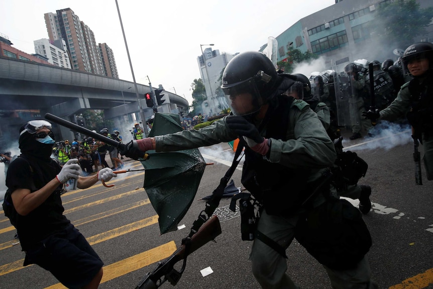protester and police officer clash in Hong Kong