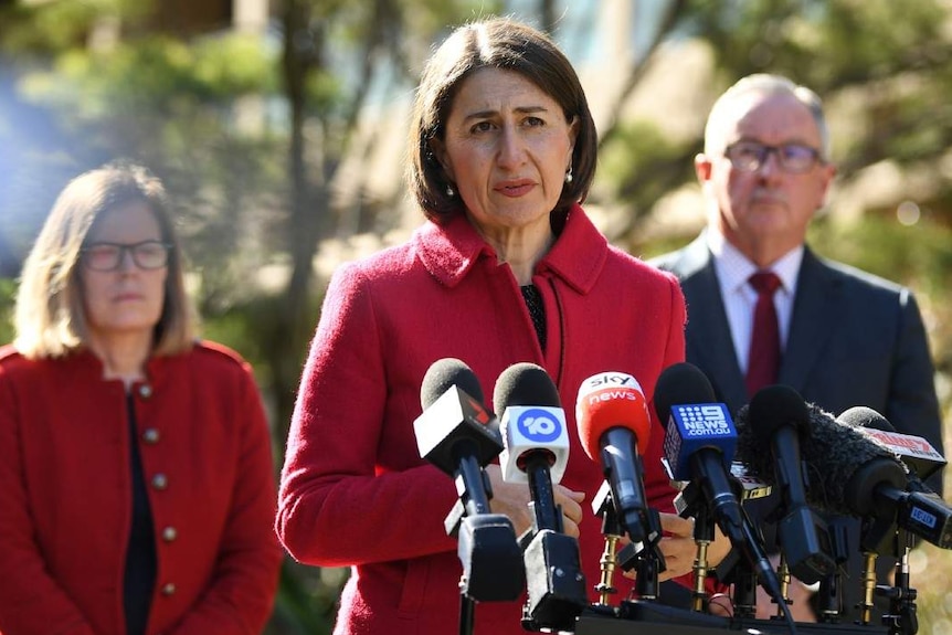 A woman talks to the media