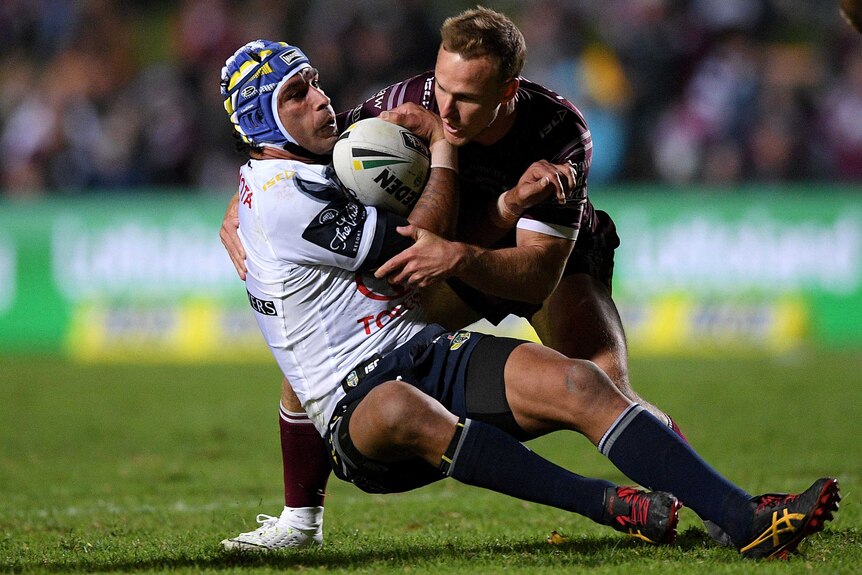Johnathan Thurston is tackled by Daly Cherry-Evans.