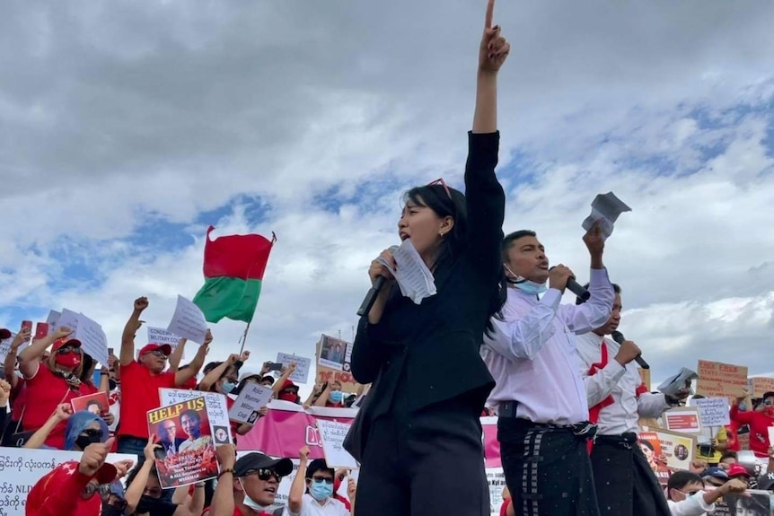 Woman holding a microphone with her fist in the air