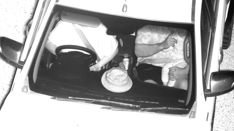Surveillance cameras show a child sitting on the lap of a passenger in the front seat. Both are wearing the one seatbelt