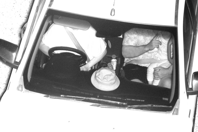 Surveillance cameras show a child sitting on the lap of a passenger in the front seat. Both are wearing the one seatbelt