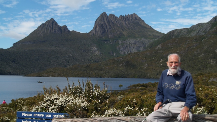 An elderly man sits in a National Park
