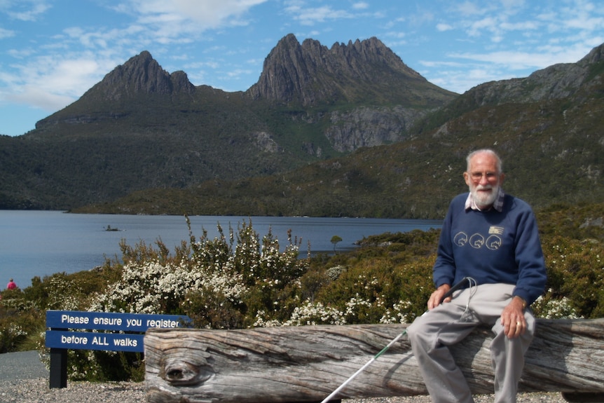 An elderly man sits in a National Park