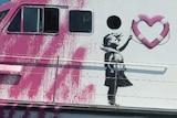 Art on side of boat shows girl in life vest