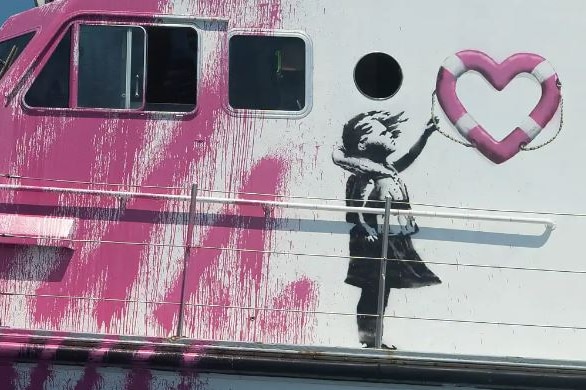 Art on side of boat shows girl in life vest