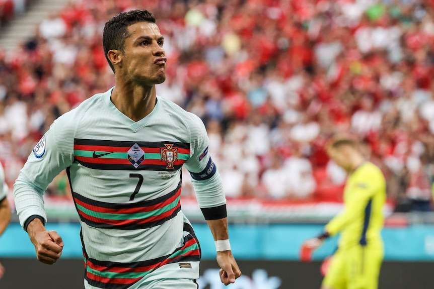 Cristiano Ronaldo pouts his lips as he runs off in celebration