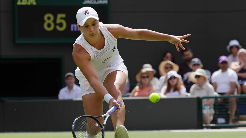 Ashleigh Barty plays a low forehand return in a first-round match at Wimbledon