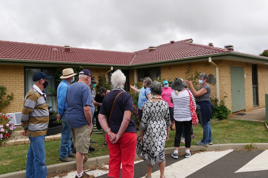 A group of people outside an aged care home