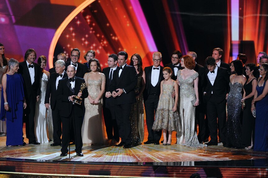 The cast and crew of Mad Men accept the Outstanding Drama Series award onstage at the Emmys