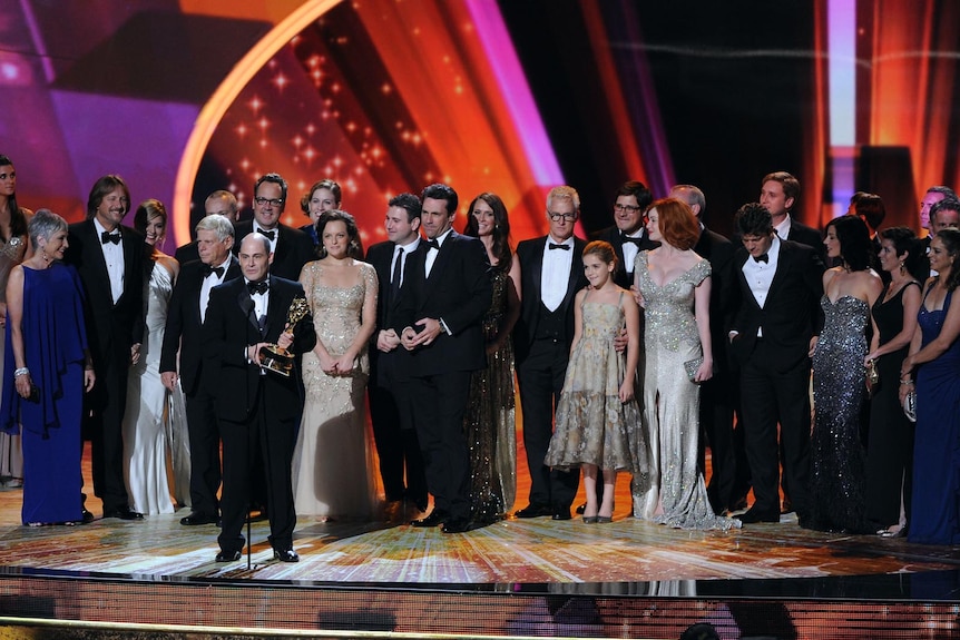 The cast and crew of Mad Men accept the Outstanding Drama Series award onstage at the Emmys