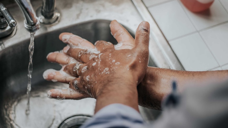 A close up shot of a person's hands at a sink as people are being advised to handwash more to stop the spread of coronavirus