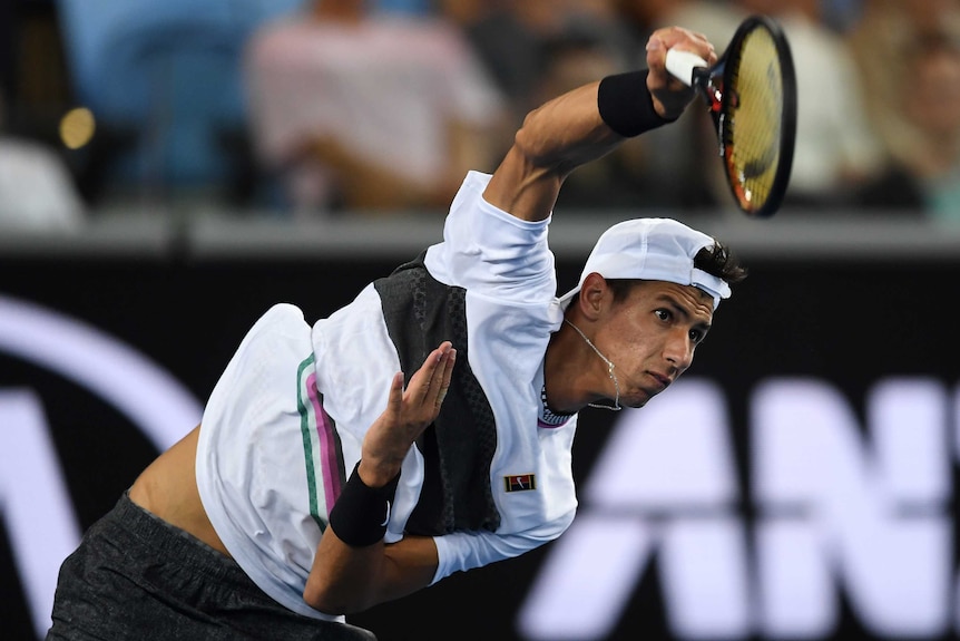 Alexei Popyrin serves a ball to Lucas Pouille at the Australian Open.