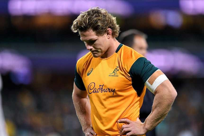 A rugby player looks dejected after a loss.