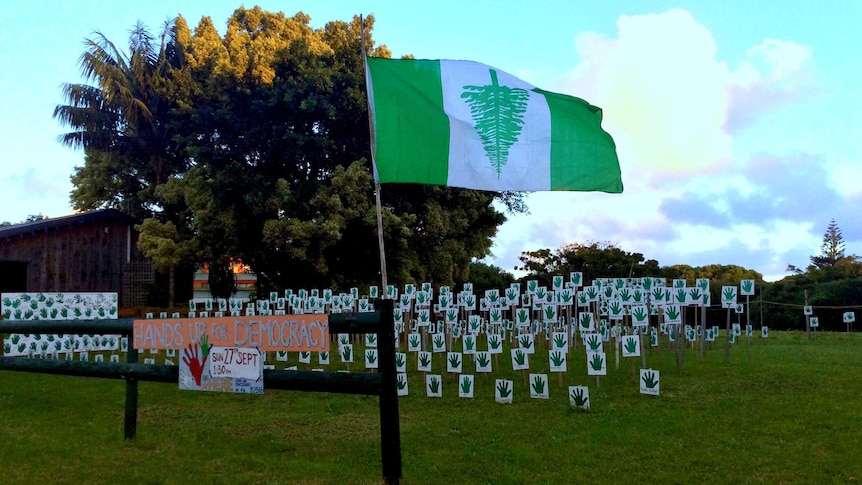 Norfolk Island flag and protest signs