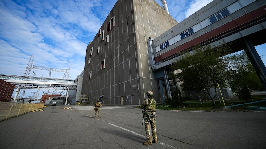 Russian servicemen guard an area of the Zaporizhzhia Nuclear Power Station.