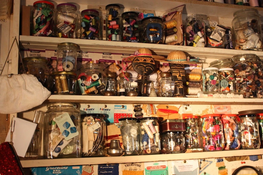 Shelves of buttons, cotton and sewing accessories.