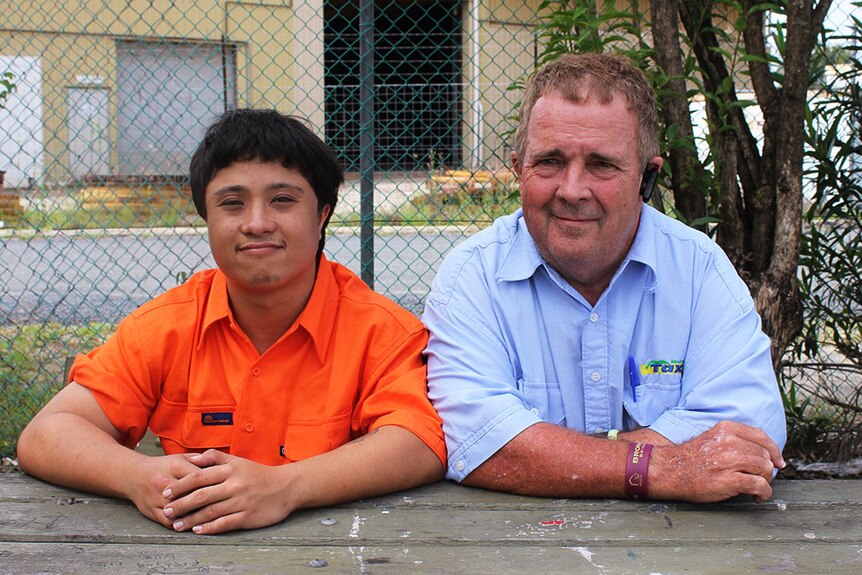 Dennis Lyons and his son Christopher smiling at the camera.