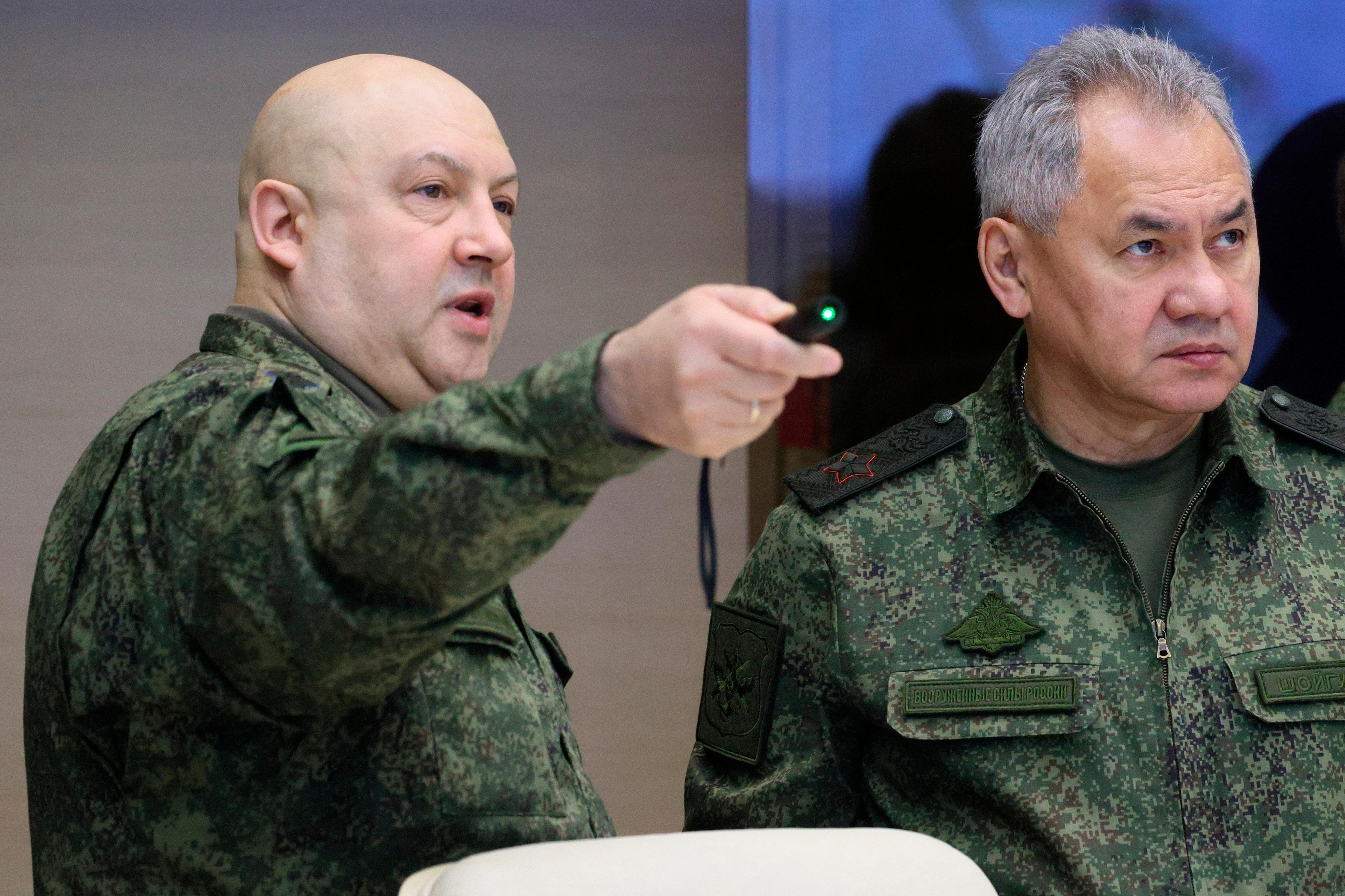 Two Russian military men in army gear gesturing,