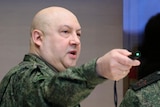 Two Russian military men in army gear gesturing,