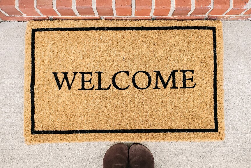 A doormat reading 'welcome'
