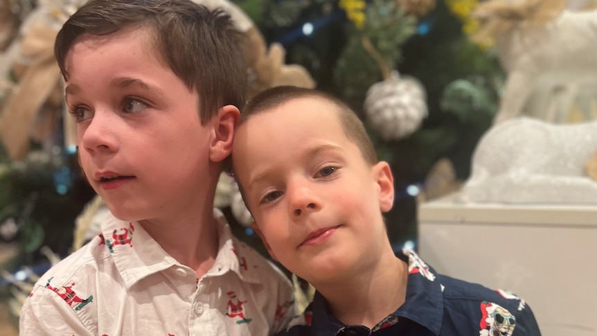 two little boys looking at the camera 