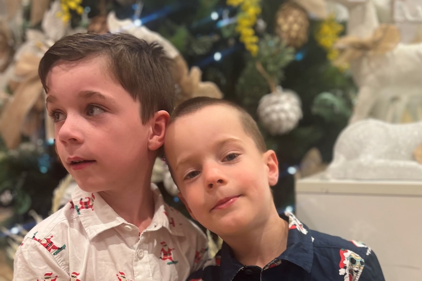 two little boys looking at the camera 