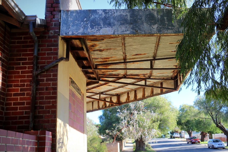 The rusty exterior of an old corner store sits in a leafy neighbourhood in East Victoria Park.