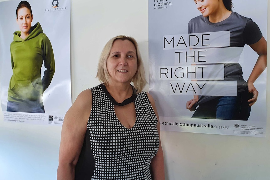 A woman stands up in front of two posters and one of them says made the right way